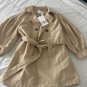 Girls size 8 trench coat with trendy puffy sleeves and plaid interior.